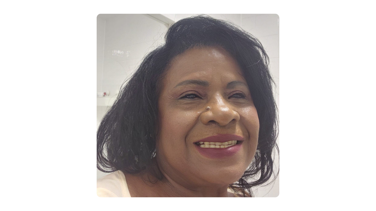 A woman smiling and looking away from the camera