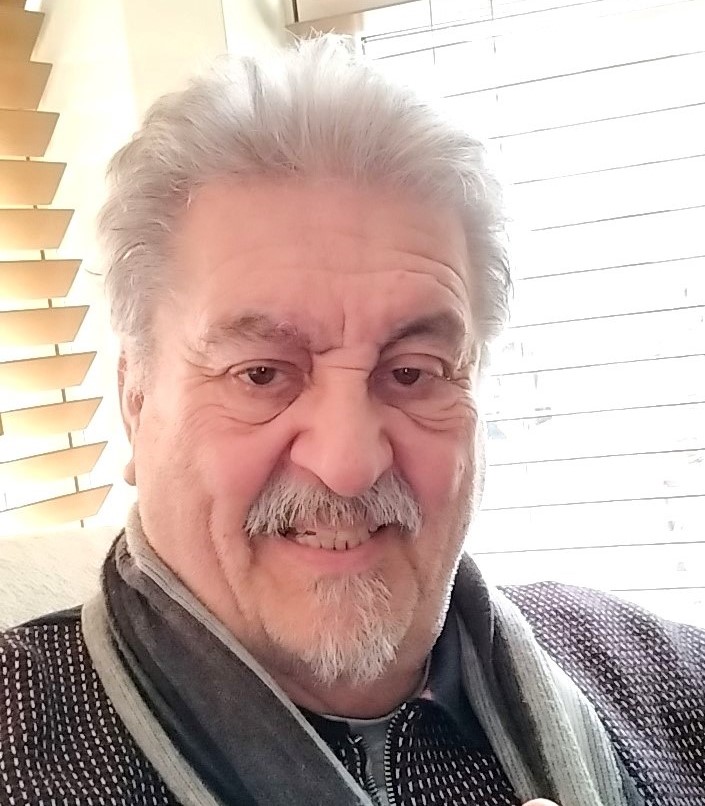 Photo of Paul with short white hair and beard