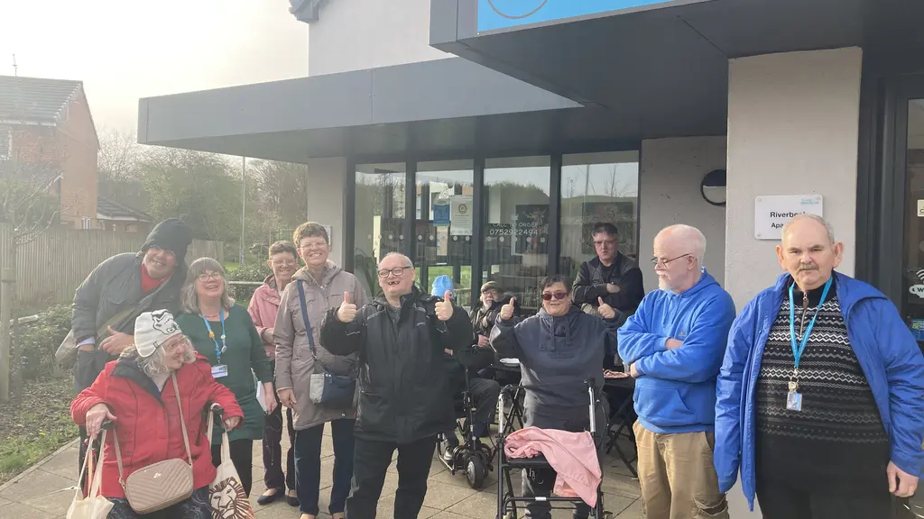 A large group of people outside a community space