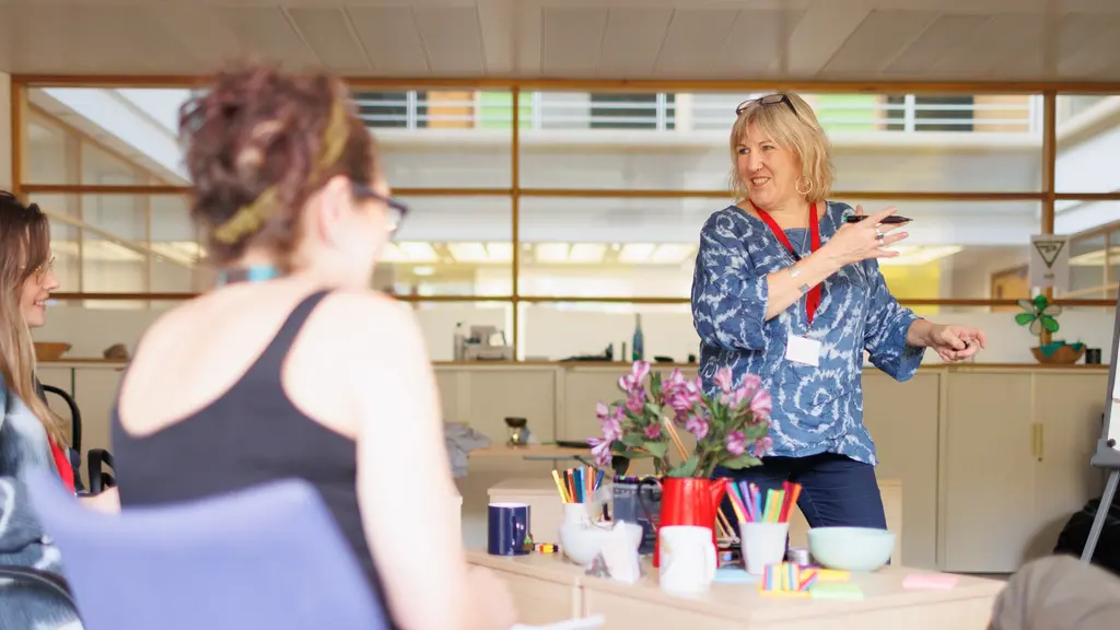A woman delivering a presentation to a small group of people