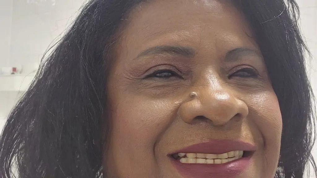 A woman smiling and looking away from the camera