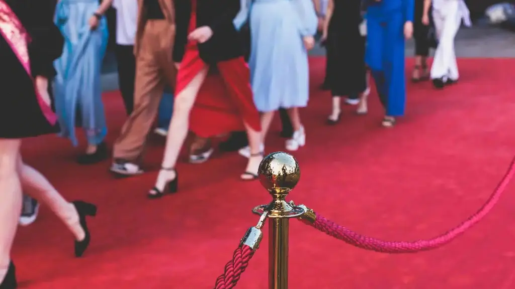 A red carpet with a view of people walking by it