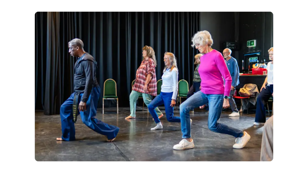 A group of older people are learning tai chi